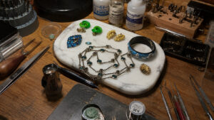 Vintage jewellery materials used for authentication including metals, crystals, enamel and pearls.